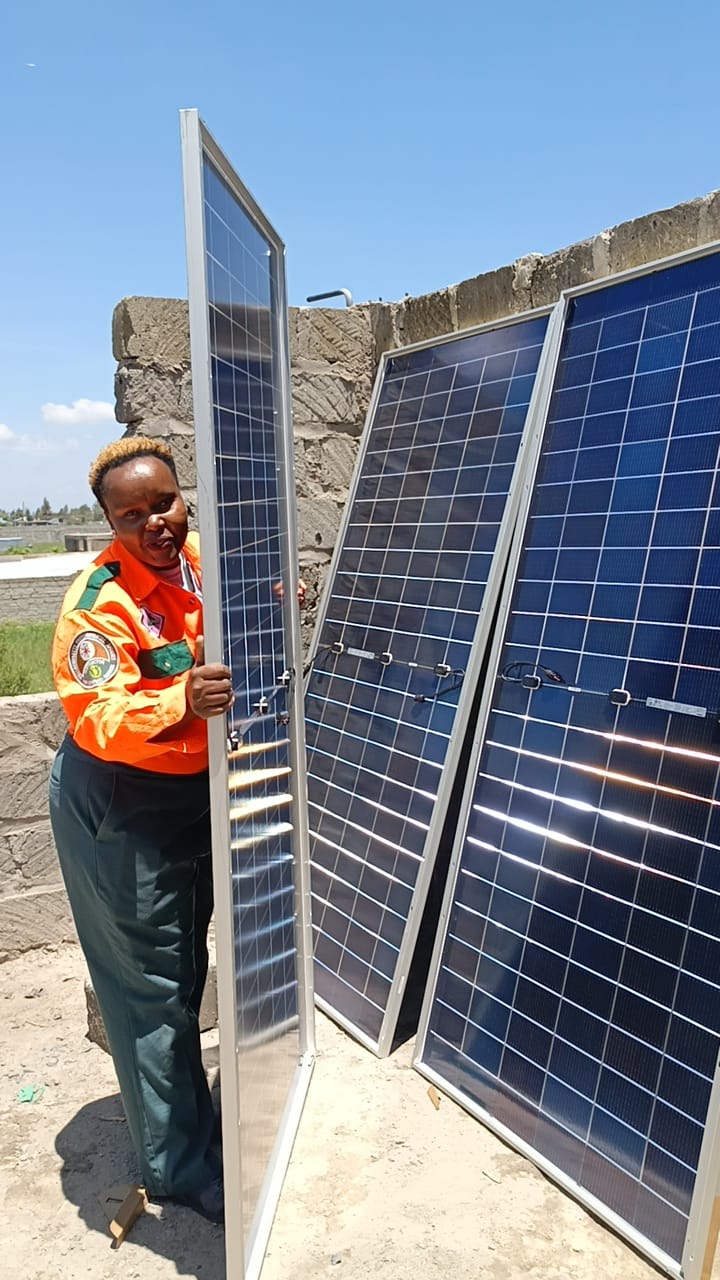 A Go Green Gold technician with solar panels on site