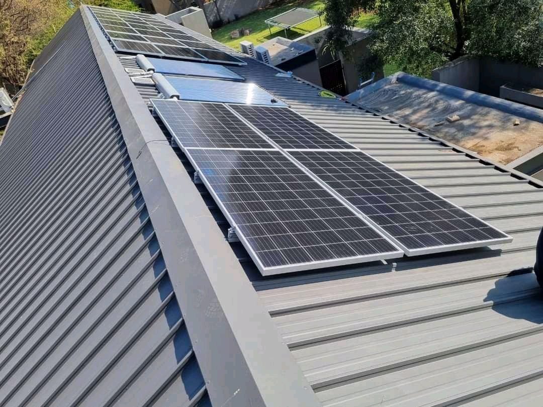 Solar panels and a flat-plate collector mounted on a metal roof