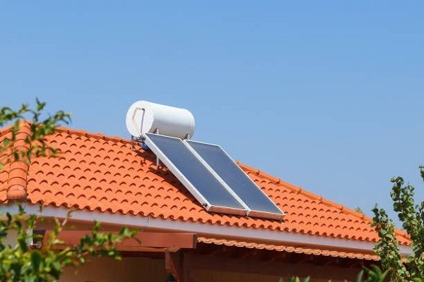A solar water heater installed on a tiled roof